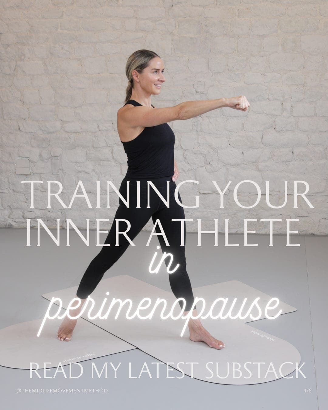 Woman performing barre lunge at the barre against a white brick wall