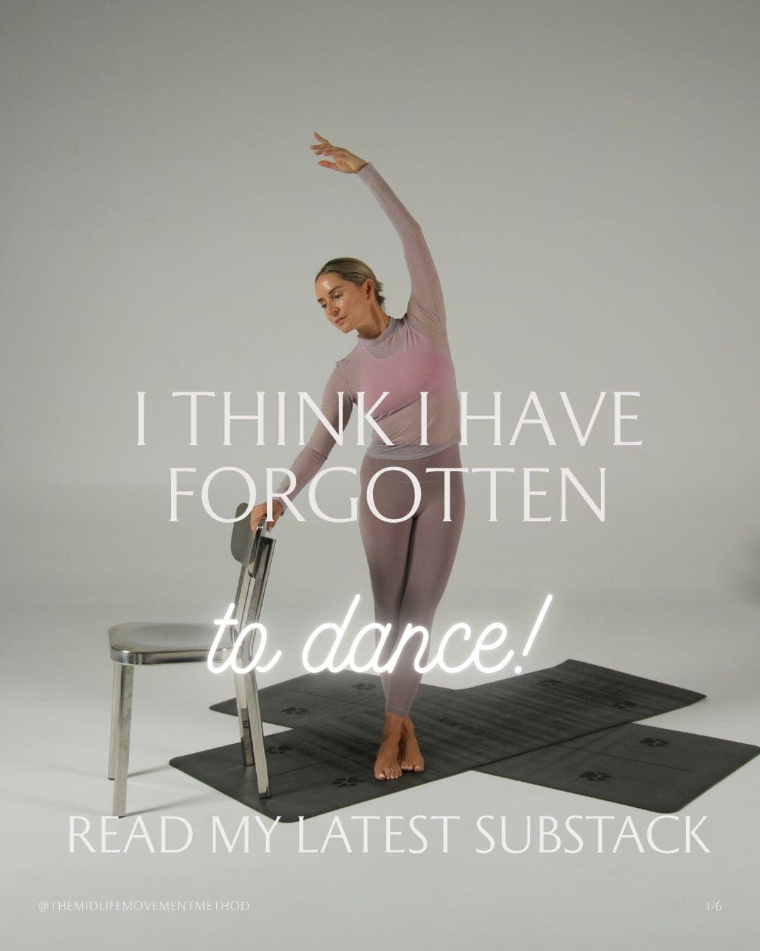 Woman performing barre exercise at chair with raised arm, on black mat in studio